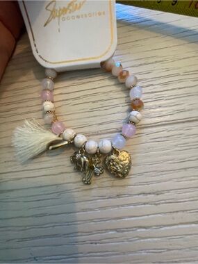 White/Pink beaded bracelet with charms and tassel